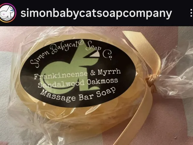 Wrapped Simon Babycat Soap Co. massage bar soap with a label reading Frankincense and Myrrh, Sandalwood Oakmoss.