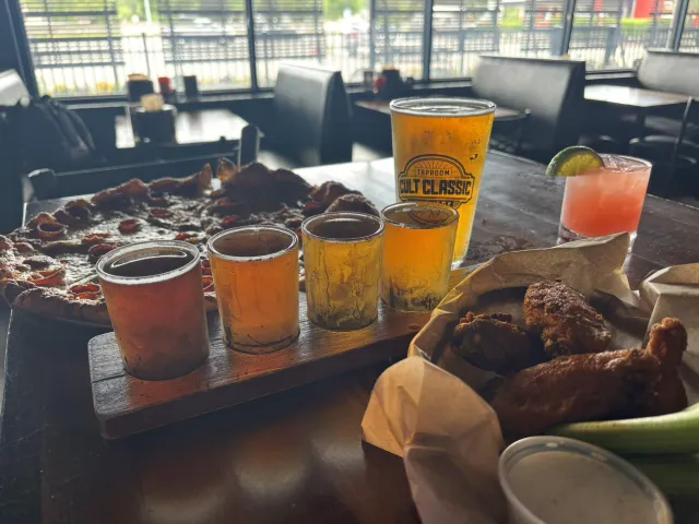 Delicious variety of golden beers, buffalo wings, and a pizza.